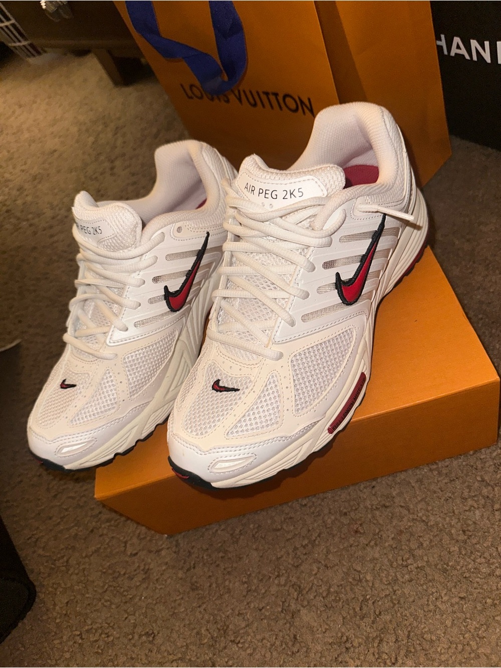 Nike White Sneakers with Red & Black Swoosh